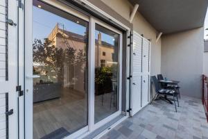 a balcony with sliding glass doors and a table at Apartment Monika in Kaštela