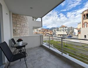 a balcony with a table and a view of a city at Margarita Flat in Tripoli