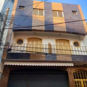 a building with a fence on the balcony at Hotel Pousada Lega's in Aparecida