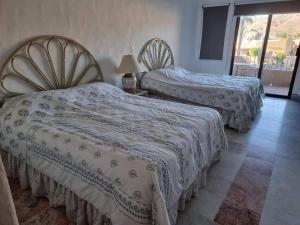 En eller flere senge i et værelse på Departamento Marinaterra