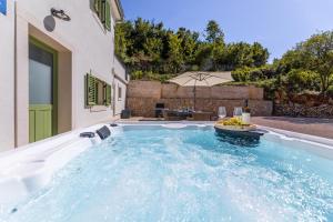 a swimming pool in the backyard of a house at Hidden House Porta in Krk