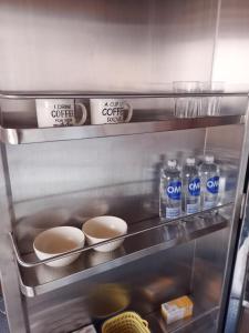 a refrigerator with some bottles of water and bowls at Villa Monserrate Bed and Breakfast in Bogotá