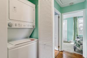 a white refrigerator in a kitchen with green walls at Wolcott Home with Deck Near Connecticut Attractions in Wolcott