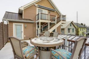 a patio with chairs and a table on a deck at Warm and Cozy Mansfield Home Deck, Gas Fire Table! in Mansfield