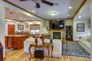 a living room with a couch and a table at Warm and Cozy Mansfield Home Deck, Gas Fire Table! in Mansfield