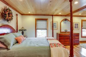 a bedroom with a bed and a dresser and a mirror at Warm and Cozy Mansfield Home Deck, Gas Fire Table! in Mansfield