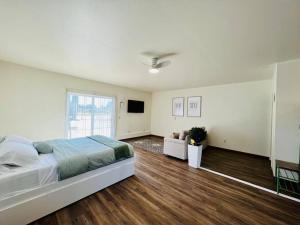 a large bedroom with a bed and a couch at Studio at Snooze in Wisconsin Rapids