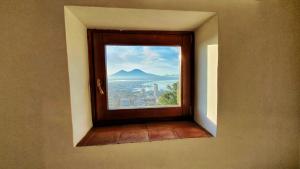 a window with a view of a mountain at Guest House Pedamentina in Naples