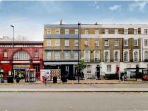 a city street with buildings on the side of a street at flat 7 mornington crescent in London