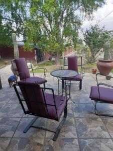 a group of chairs and a table on a patio at La Inesita in Tafí del Valle