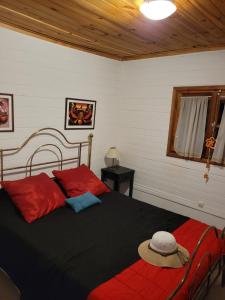 a bedroom with a bed with a hat on it at La Inesita in Tafí del Valle