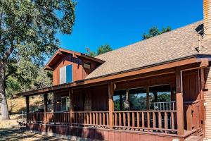 a house with a porch with a large deck at The Badger House in Badger