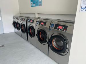 a row of washing machines in a laundry room at Ti Coco Location - Manganao Saint-François avec Citerne Tampon Automatique in Saint-François
