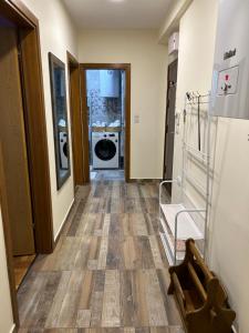 a hallway of a room with a washer and dryer at Apartman Obala in Bosanska Gradiška