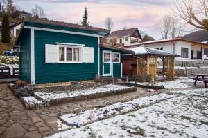 a green house with snow on the ground at Le Chalet Bed&Bath -Chez Les Alfreds in Soubey