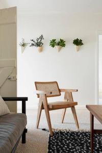 a room with a chair and a table with potted plants at Stoneycroft Cottage ~ Grampians Farm Stay 