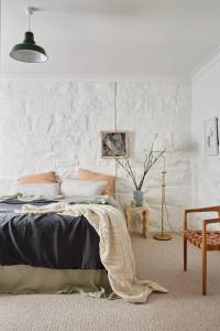 a bedroom with a bed and a wall at Stoneycroft Cottage ~ Grampians Farm Stay 