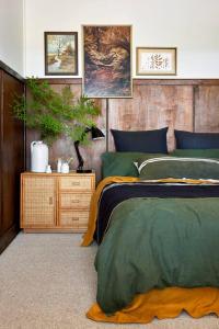 a bedroom with a bed and a table with a plant at Stoneycroft Cottage ~ Grampians Farm Stay 