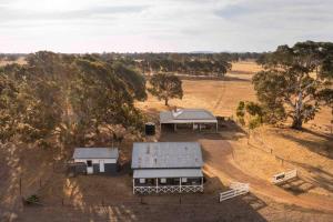 an aerial view of two buildings in a field at Stoneycroft Cottage ~ Grampians Farm Stay 