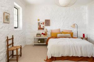 a bedroom with a large bed and a chair at Stoneycroft Cottage ~ Grampians Farm Stay 
