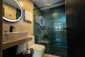 a bathroom with a sink and a toilet and a mirror at Hotel Expo Alcalá, a 1 min de Plaza del Sol in Guadalajara +30 photos