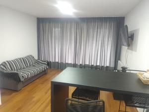 a living room with a table and a couch at Alquiler Temporario Rosario 14 in Rosario