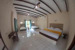 a bedroom with a bed and a table in a room at Tarcoles Birding Lodge in Tarcoles +31 photos