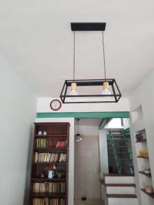 a chandelier hanging in a room with a book shelf at ALPATACAL in Rosario