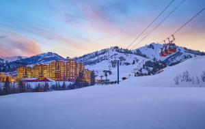 a ski resort in the snow with a ski lift at Grand Summit Hotel - Canyons Village, a RockResort by Vail Resorts in Park City