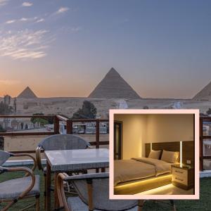 a bedroom with a bed and the pyramids in the background at Narmer Pyramids View in Cairo
