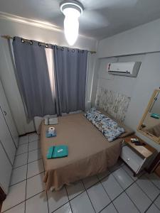 a small room with a bed and a window at Apto Centro Floripa 01 in Florianópolis