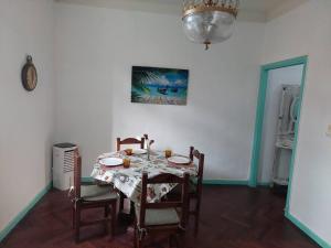 a dining room with a table and chairs and a clock at Comfortable Apartment in Colegiales in Buenos Aires