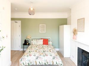 a bedroom with a bed and a fireplace at FOSSE LUXURY ROOMS in Leicester