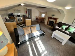 a living room with a couch and a table at The Hideaway Holywell in Holywell