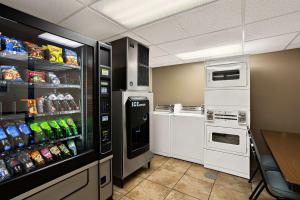 a kitchen with a refrigerator with drinks in it at Best Western Center Pointe Inn in Branson