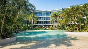 a resort with a swimming pool in front of a building at 2BR Resort Living: 2-Bed Haven in Gold Coast