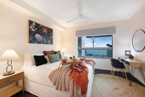 a bedroom with a bed and a desk and a window at 'High-Top Retreat' City Chic With Ocean Outlooks in Darwin +28 photos