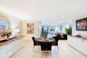 a kitchen and living room with a table and chairs at 'High-Top Retreat' City Chic With Ocean Outlooks in Darwin