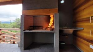 a brick oven with a fire in it at Sueño Serrano in Santa Rosa de Calamuchita