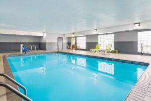 a large swimming pool in a hotel room at Country Inn & Suites by Radisson, Stillwater, MN in Stillwater
