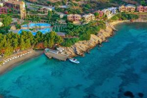 an aerial view of a beach with a boat in the water at Candia Park Village in Agios Nikolaos