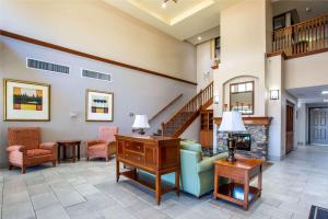 a lobby with a couch and chairs and a fireplace at Country Inn & Suites by Radisson, Tucson City Center AZ in Tucson