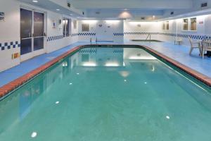 a large swimming pool in a building at Country Inn & Suites by Radisson, Fresno North, CA in Fresno