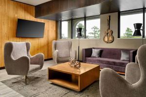 a living room with a couch and chairs and a table at Radisson Hotel West Memphis in West Memphis