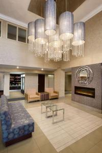a lobby with a couch and a table and chandeliers at Park Inn by Radisson Toronto-Markham in Markham