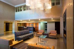 a lobby with couches and chairs and a television at Park Inn by Radisson Toronto-Markham in Markham