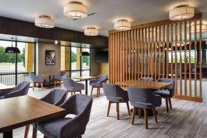 a restaurant with tables and chairs and windows at Radisson Hotel West Memphis in West Memphis