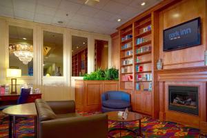 a waiting room with a fireplace and a tv at Park Inn By Radisson Sharon in West Middlesex