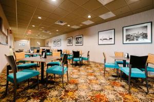 a dining room with tables and chairs and pictures on the wall at Radisson Hotel St Paul Downtown in Saint Paul