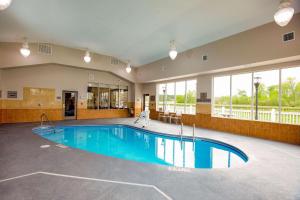 a large swimming pool in a large room with windows at Country Inn & Suites by Radisson, Wilson, NC in Wilson